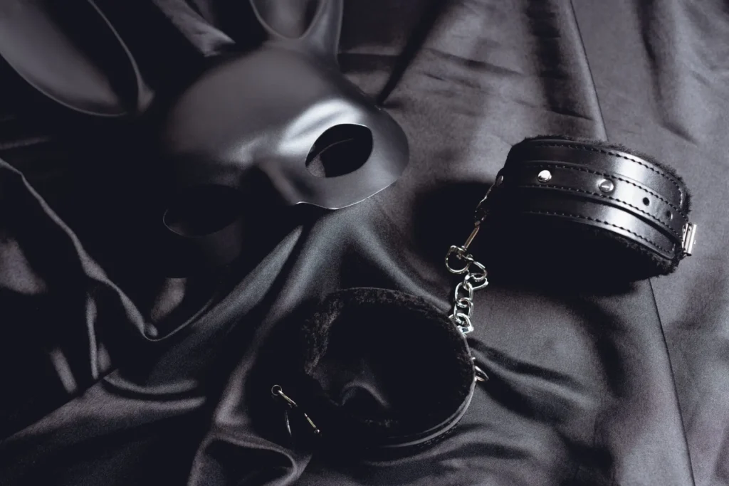 wisted Tantric™ London — Bespoke Dark Tantra Experience Black leather mask and cuffs representing a bespoke dark tantra session in London